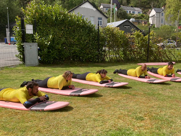Business team learning to surf